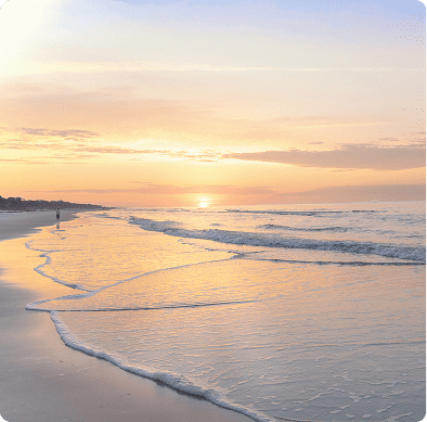 Sunrise over calm beach with gentle waves